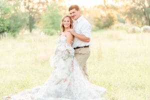 maternity couple in an open field