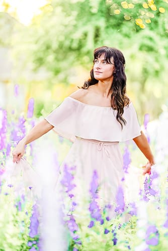 photo of Jessica LaRen an Ocala Florida photographer in a field of larkspur flowers