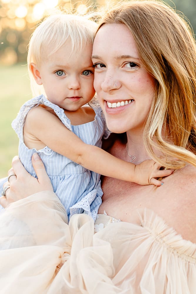 mom and toddler smiling at camera