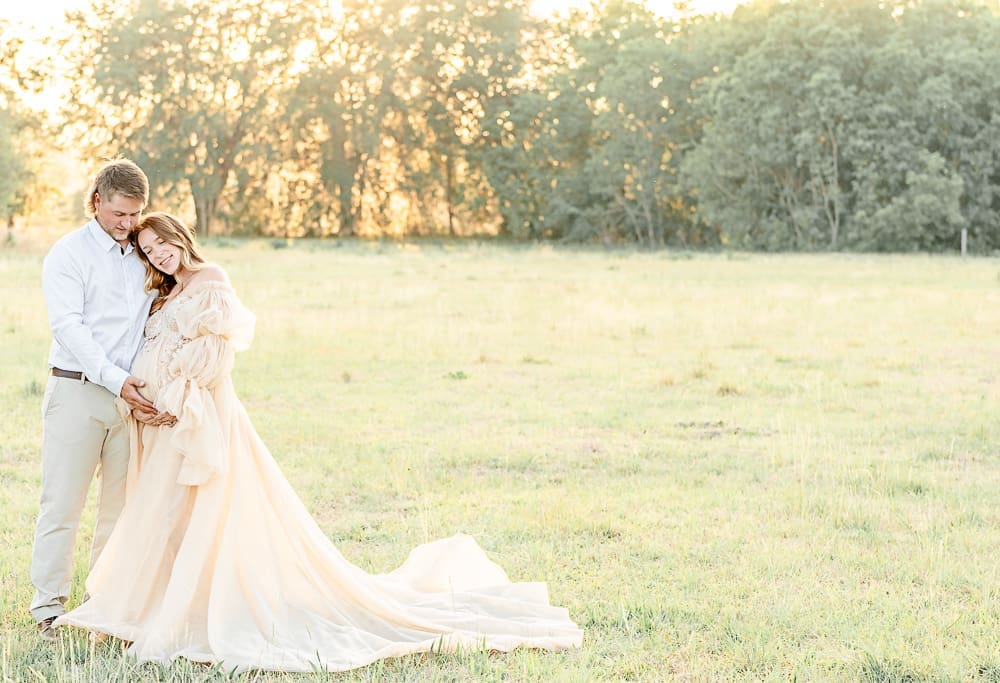 husband and wife in a glowy afternoon field