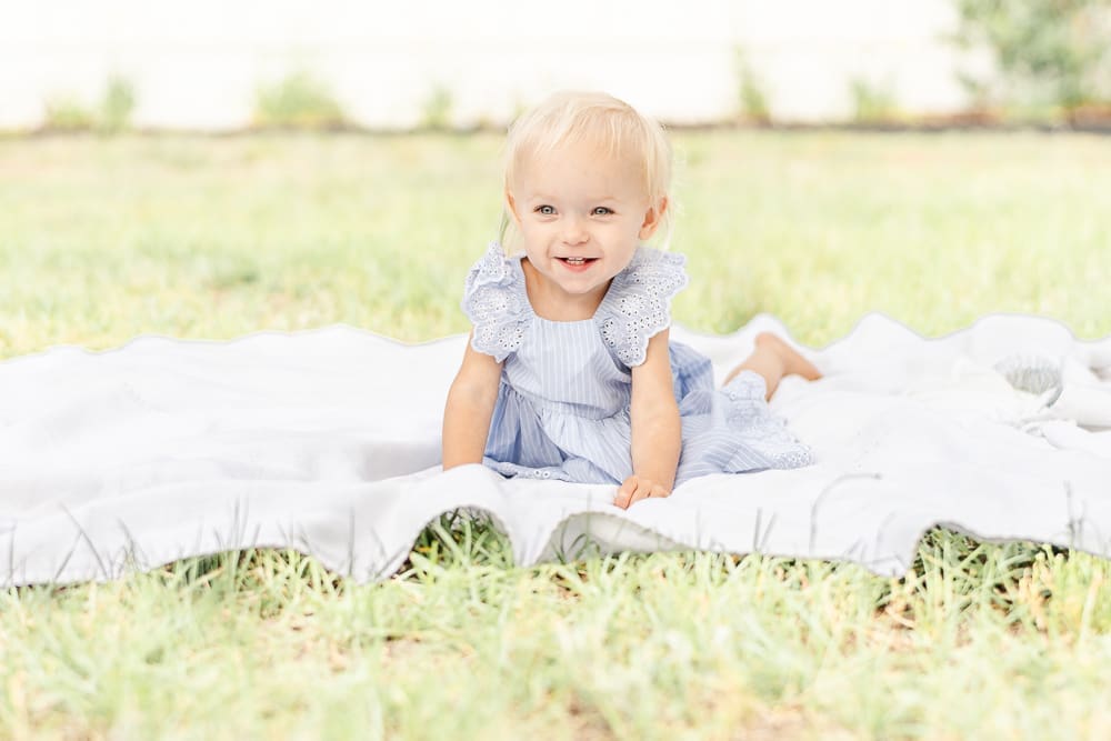 toddler laughing on blanket