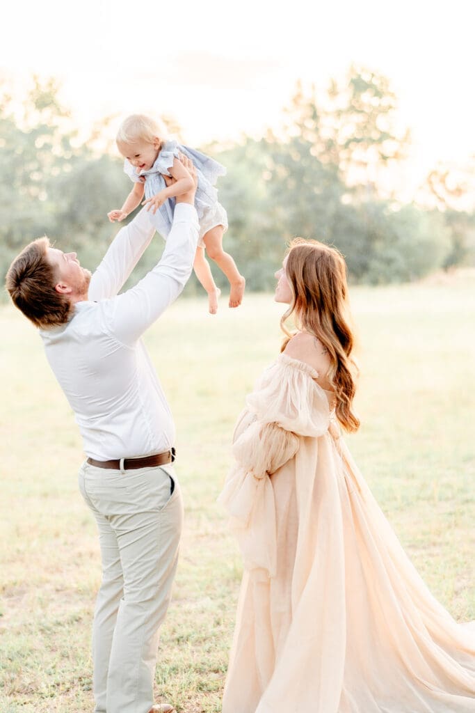 dad throwing toddler in the air
