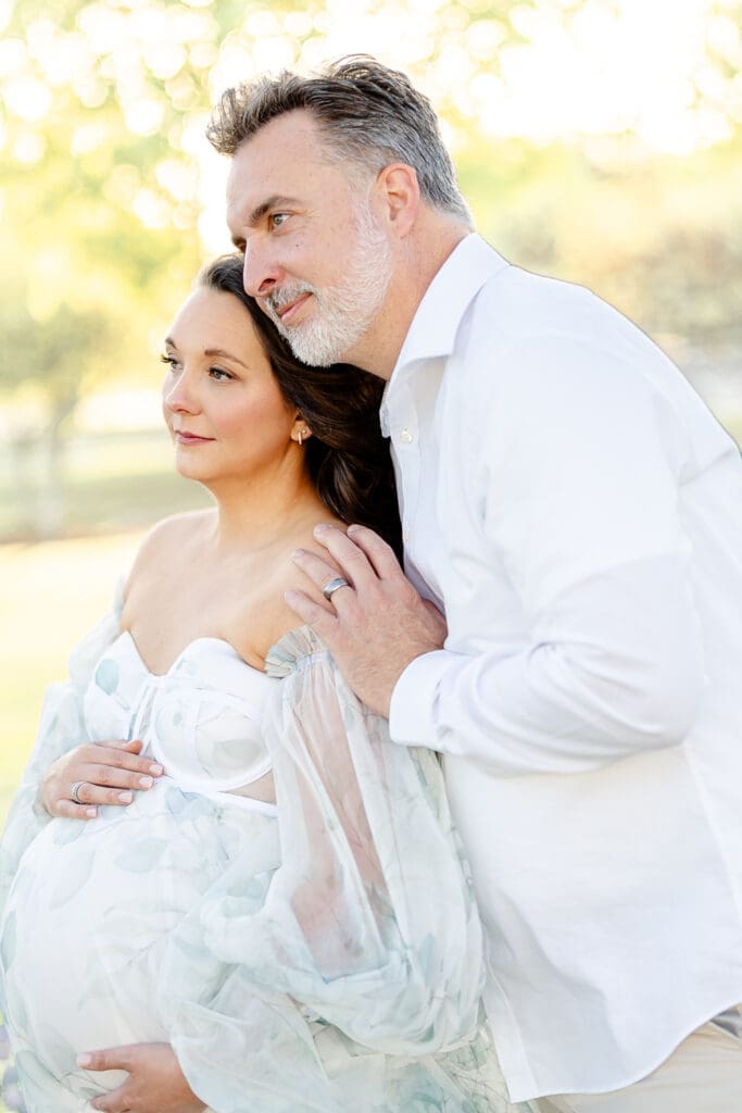 A husband and wife close together while the envision the arrival of their baby girl.